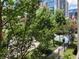 Exterior view overlooking trees on the street with a view of city buildings in the distance at 1075 Peachtree Walk # A205, Atlanta, GA 30309