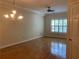 A cozy living room with hardwood floors, natural light and chandelier at 1075 Peachtree Walk # A205, Atlanta, GA 30309