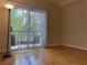 Bright living room with hardwood floors and a sliding glass door to a private balcony at 1075 Peachtree Walk # A205, Atlanta, GA 30309