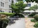 Private outdoor patio with seating, a waterfall feature, and lush landscaping, perfect for relaxation at 1075 Peachtree Walk # A205, Atlanta, GA 30309