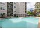 Community swimming pool with lounge area and a view of nearby buildings and landscaping at 1075 Peachtree Walk # A205, Atlanta, GA 30309
