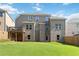 Expansive backyard featuring a well-manicured lawn and partial view of a brick home at 2031 Broadmoor Way, Fairburn, GA 30213