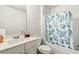 Bathroom with single sink vanity, toilet, and tub shower with patterned curtain at 2031 Broadmoor Way, Fairburn, GA 30213