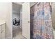Bathroom with single sink vanity, toilet, and tub shower with patterned curtain at 2031 Broadmoor Way, Fairburn, GA 30213
