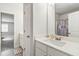 Bathroom with single sink vanity, toilet, and tub shower with patterned curtain at 2031 Broadmoor Way, Fairburn, GA 30213