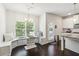 Cozy breakfast nook with window seating and a stylish chandelier adjacent to kitchen at 2031 Broadmoor Way, Fairburn, GA 30213
