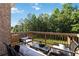 Relaxing deck area with comfortable seating and a view of the wooded backyard at 2031 Broadmoor Way, Fairburn, GA 30213