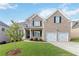 Charming two-story brick home with a well-manicured lawn and a two-car garage at 2031 Broadmoor Way, Fairburn, GA 30213