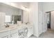 Bright bathroom with double vanity and framed mirror as well as a separate shower at 2031 Broadmoor Way, Fairburn, GA 30213