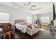 Spacious main bedroom featuring a tray ceiling, hardwood floors, and ample natural light at 2031 Broadmoor Way, Fairburn, GA 30213