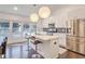 Kitchen with white cabinets, stainless steel appliances, an island with barstools, and a dining area at 2344 Belmont Dr, Decatur, GA 30032