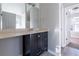 Bathroom featuring black vanity, large mirror, modern fixtures, and hardwood-style flooring at 2931 Two Lake Cir, Atlanta, GA 30349