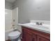 Bathroom featuring vanity with sink, toilet, and shower-tub combo with white tile surround at 2931 Two Lake Cir, Atlanta, GA 30349