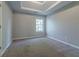 Bedroom featuring neutral paint, plush carpet, trey ceiling, and large window at 2931 Two Lake Cir, Atlanta, GA 30349