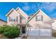 Charming two-story home featuring a two-car garage, inviting front porch, and manicured landscaping at 2931 Two Lake Cir, Atlanta, GA 30349