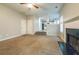 Open concept living room with fireplace, ceiling fan, and hardwood floors leading into the kitchen at 2931 Two Lake Cir, Atlanta, GA 30349