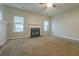 Spacious living room with neutral carpeting and a fireplace feature, lit by natural light at 2931 Two Lake Cir, Atlanta, GA 30349