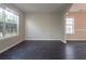 Living room with ample natural light streaming through two windows, complemented by stylish hardwood flooring at 2931 Two Lake Cir, Atlanta, GA 30349
