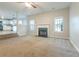 Open living room with fireplace and view into bright kitchen, enhanced with ceiling fan at 2931 Two Lake Cir, Atlanta, GA 30349