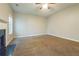 Empty living room featuring a fireplace, neutral walls, plush carpet, and natural light from a window at 2931 Two Lake Cir, Atlanta, GA 30349