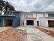 New construction townhomes featuring a mix of blue and white siding, driveway, and attached garage under construction at 4428 Ryan St, Douglasville, GA 30135
