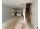 Spacious unfinished interior with stairs and kitchen area showcasing potential for customization at 4428 Ryan St, Douglasville, GA 30135
