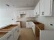 Spacious kitchen featuring white cabinets, stainless steel hardware, and an island, ready for your personal touch at 4428 Ryan St, Douglasville, GA 30135