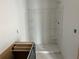 Bathroom featuring a shower stall with built-in shelving, awaiting final installation of vanity at , Douglasville, GA 30135