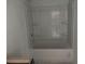 Bathroom showcasing a tub and shower combination with built-in shelving, awaiting vanity installation at , Douglasville, GA 30135