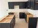 An unfinished kitchen area with modern black cabinets, ready for appliances and countertops at , Douglasville, GA 30135