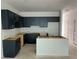 An unfinished kitchen area with modern black cabinets and an island, ready for appliances at , Douglasville, GA 30135