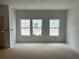 Unfinished living room showcasing ample natural light from three large windows and recessed lighting at , Douglasville, GA 30135