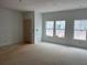 Unfinished living room showcasing ample natural light from three large windows and a door at , Douglasville, GA 30135