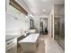 This bathroom features a soaking tub, stand-up glass shower, a window, and a decorative framed mirror at 10580 Grandview Sq, Johns Creek, GA 30097