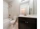 Full bathroom with tub, shower, tile surround, dark cabinets, and a large mirror at 10580 Grandview Sq, Johns Creek, GA 30097