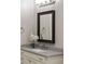 Close up on the bathroom vanity, featuring a framed mirror, white orchid, and brushed nickel faucet at 10580 Grandview Sq, Johns Creek, GA 30097