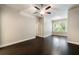 Cozy bedroom featuring hardwood floors, neutral walls, and a ceiling fan at 10580 Grandview Sq, Johns Creek, GA 30097