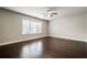 Bright bedroom with hardwood floors, a large window, and neutral paint at 10580 Grandview Sq, Johns Creek, GA 30097