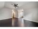 Bright bedroom with ceiling fan and hardwood floors, offering generous space and a view into the hallway at 10580 Grandview Sq, Johns Creek, GA 30097