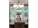Dining room with a modern chandelier and a view of the green outdoors at 10580 Grandview Sq, Johns Creek, GA 30097