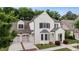 Stunning two-story home with white brick, contrasting shutters, and a manicured front yard for curb appeal at 10580 Grandview Sq, Johns Creek, GA 30097