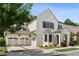 Beautifully landscaped two-story white brick home with attached two-car garage and an inviting front entrance at 10580 Grandview Sq, Johns Creek, GA 30097