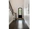 Bright foyer with hardwood floors, staircase with dark wood railing, and an elegant front door with glass panels at 10580 Grandview Sq, Johns Creek, GA 30097