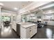 Spacious kitchen island with sink and dishwasher overlooking the living and dining areas at 10580 Grandview Sq, Johns Creek, GA 30097