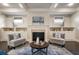 Cozy living room featuring a fireplace with built-in shelving, neutral colors, and comfortable seating at 10580 Grandview Sq, Johns Creek, GA 30097