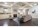 Open concept living room with coffered ceiling, fireplace, hardwood floors, and neutral decor at 10580 Grandview Sq, Johns Creek, GA 30097