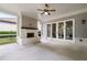This outdoor patio features a brick fireplace, ceiling fan, and a large sliding glass door entry at 10580 Grandview Sq, Johns Creek, GA 30097