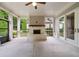 This outdoor patio features a brick fireplace, a ceiling fan, and screened windows overlooking the yard at 10580 Grandview Sq, Johns Creek, GA 30097