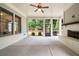 Inviting screened porch with ceiling fan, fireplace, and serene views of the backyard at 10580 Grandview Sq, Johns Creek, GA 30097