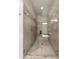 This glass shower features tile detailing, built-in seat, brushed nickel shower head, and glass doors at 10580 Grandview Sq, Johns Creek, GA 30097